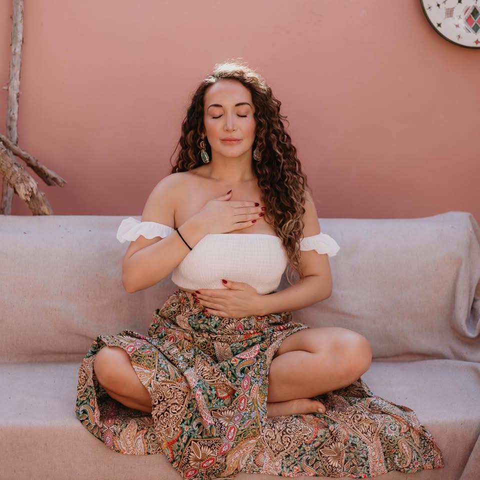 Georgina Brooker meditating with hands on heart and belly